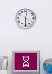 Clock on wall above computer 